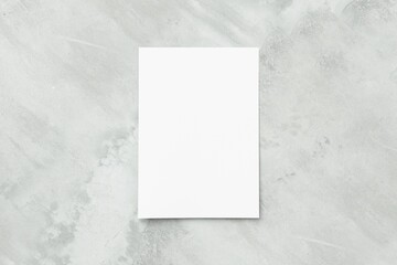 Blank white A4 paper sheet on concrete floor