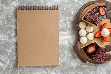 top view yummy cake slices with choco cookies on a white background sweet cakes dessert