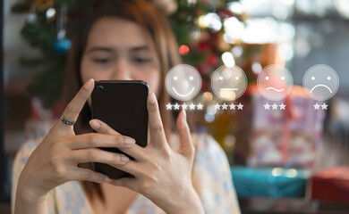 Customer Experience Concept  Business women holding the smartphone with Smiley Face icon for Rating 