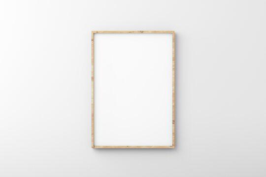Thin wooden empty frame on white wall for mockup
