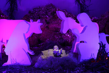 Nativity scene in silhouettes with purple lights