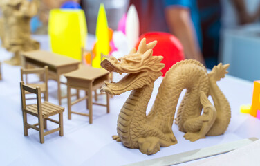 3D printer printing dragon head figure close-up.