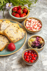 front view yummy cake slices with strawberries on a light background fruit sweet cake pie