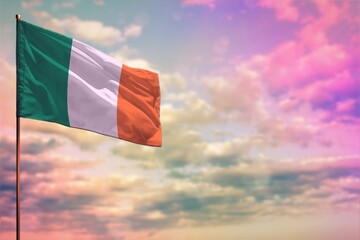 Fluttering Ireland flag mockup with the space for your content on colorful cloudy sky background.