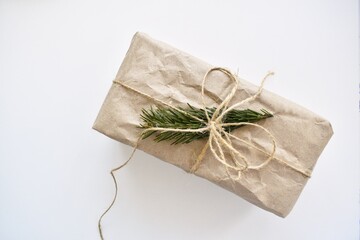 Gift box with Christmas tree branch on a white background