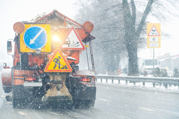 Snowplow truck removes snow on the winter road	

