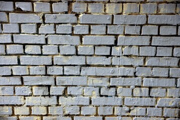 gray stone texture of dirty bricks in an old building wall on the street
