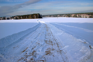 Beautiful scenery.  The winter road cuts deep into the snow and runs, curving and losing itself in the forest.
