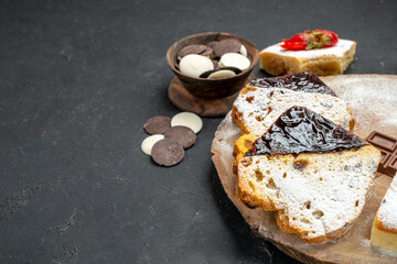 front view delicious cake slices with choco bars on a dark background biscuit fruit sweet