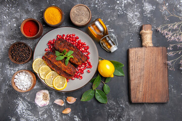 Fototapeta na wymiar top view tasty meat cutlets with seasonings on grey background dish photo food