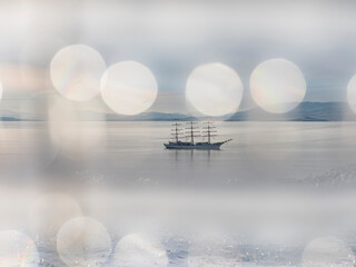 Sailing boat at the background with bokeh lights in the sky