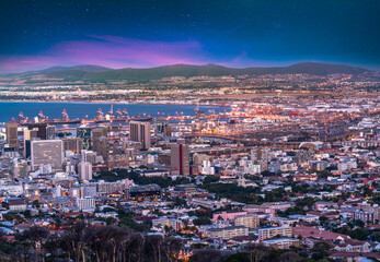 Fototapeta premium Cape Town city and harbour illuminated at night with twilight stars in the sky