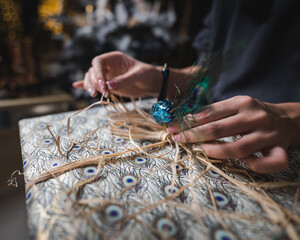 Female hands wrapping the Christmas present. Preparing present for boyfriend. Christmas holidays concept. Surprise for someone. Female hands close up.