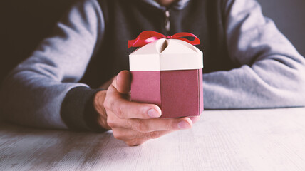 man holding a gift in his hand
