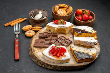 front view cake slices with cookies and chocolate on dark background pie biscuit sweet
