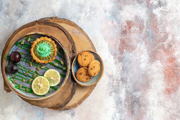 top view little creamy cake with fruits on light floor biscuit candy photo sweet