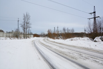 Snow-covered road in a snow-covered pine forest