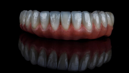 dental prosthesis of the lower jaw made of high quality ceramic on a black background