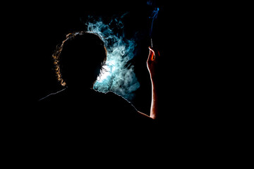 Colored silhouette of a smoking man on dark background.