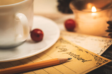Romantic letter, greetings card with pencil, evening by candlelight and on plaids, warm and cozy tone