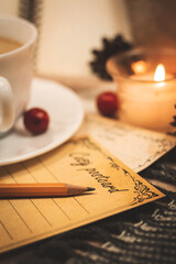 Romantic letter, greetings postcard with pencil, evening by candlelight and plaids, warm and cozy tones, vertical photo