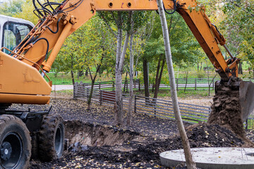 Excavator loader during earthworks at a construction site. An excavator digs land for the...