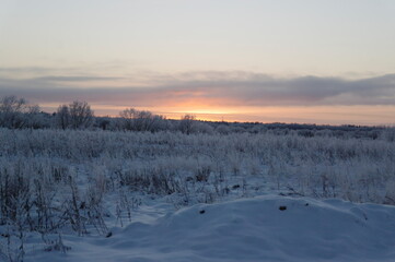 sunset over a snow field in russia