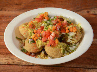 Masala puri is a famous midday snack in india, served over a rustic wooden background, selective focus