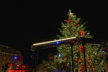 Thessaloniki, Greece decorated Christmas tree at Aristotelous square. Night view of illuminated festive instalments at southern part of main city square.