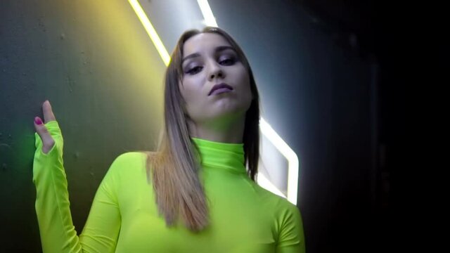 Fashionable girl on a background of a neon lamps