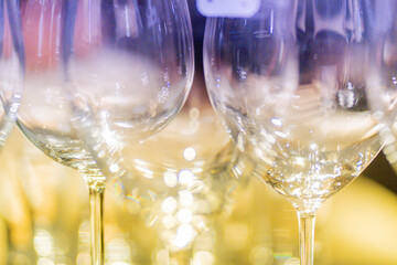 The light shines beautifully on a wine glass in pastel tones