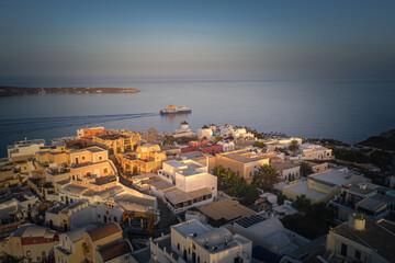 Naklejka premium Oia town on Thira. Santorini island with colorful volcanic cliffs and deep blue sea aerial view