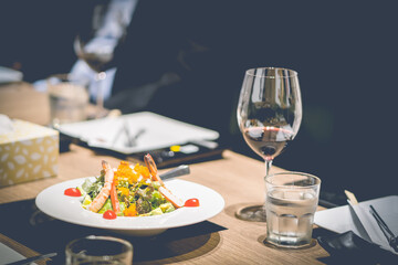 Dinner is placed on the dining table in a fine dining restaurant