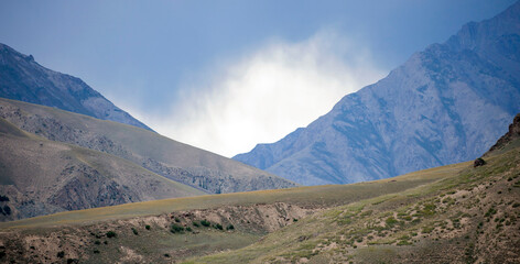  Dark thundercloud over a mountain pass before the weather worsens.