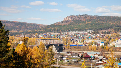 View of the Siberian city of Ust-Kut and the automobile bridge over the Lena River in autumn.