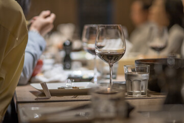 A glass of red wine was placed on the dining table at a feast