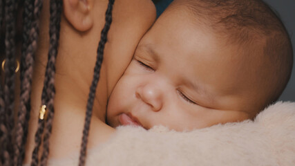 Close up of beautiful baby sleeping in mothers hands. High quality photo