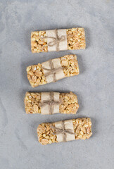 Energy food, nutty oatmeal bars on paper on a light gray background top view