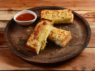 Cheese garlic bread, served over a rustic wooden background, selective focus