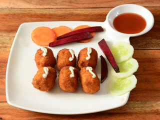 Cheese Nuggets, served over a rustic wooden background, selective focus