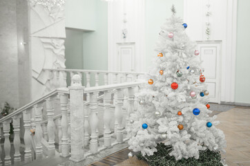 Christmas decorations on the tree. White Christmas tree.
