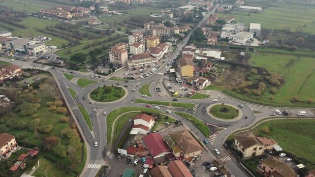 Time lapse: aerial view of a city. Urban landscape in the evening, daylight. Moving cars on the street, drone above. Speed concept during a sunny day.