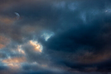Naklejka na ściany i meble Mottled dark sunset sky with moon barely showing