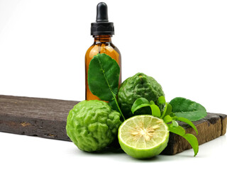 Bergamot essential oil herb with fruit and leaves on wooden background, isolated on white background.