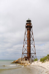 Fototapeta na wymiar lighthouse on the sandy with grass shore of the Black Sea