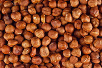 Peeled hazelnuts close up. Texture of nuts. Lots of nuts in a pile.