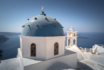Panoramic view with Greek orthodox church with blue domes  in Santorini, Greece