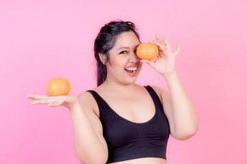 Overweight asian plump female with orange - lifestyle Woman diet weight loss overweight problem concept