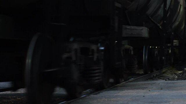 Wheels of a train carrying oil tanks. Transportation of goods by Rail.