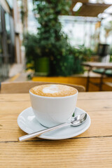 cup of coffee with milk on a wooden table